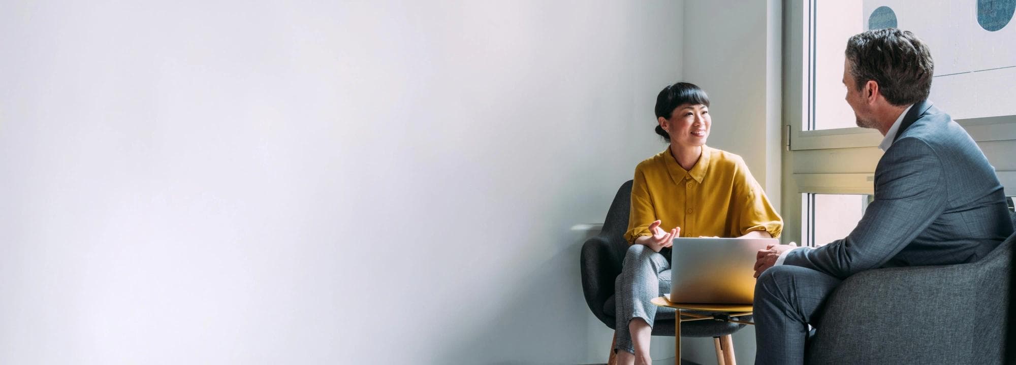 Woman and man talking at a desk