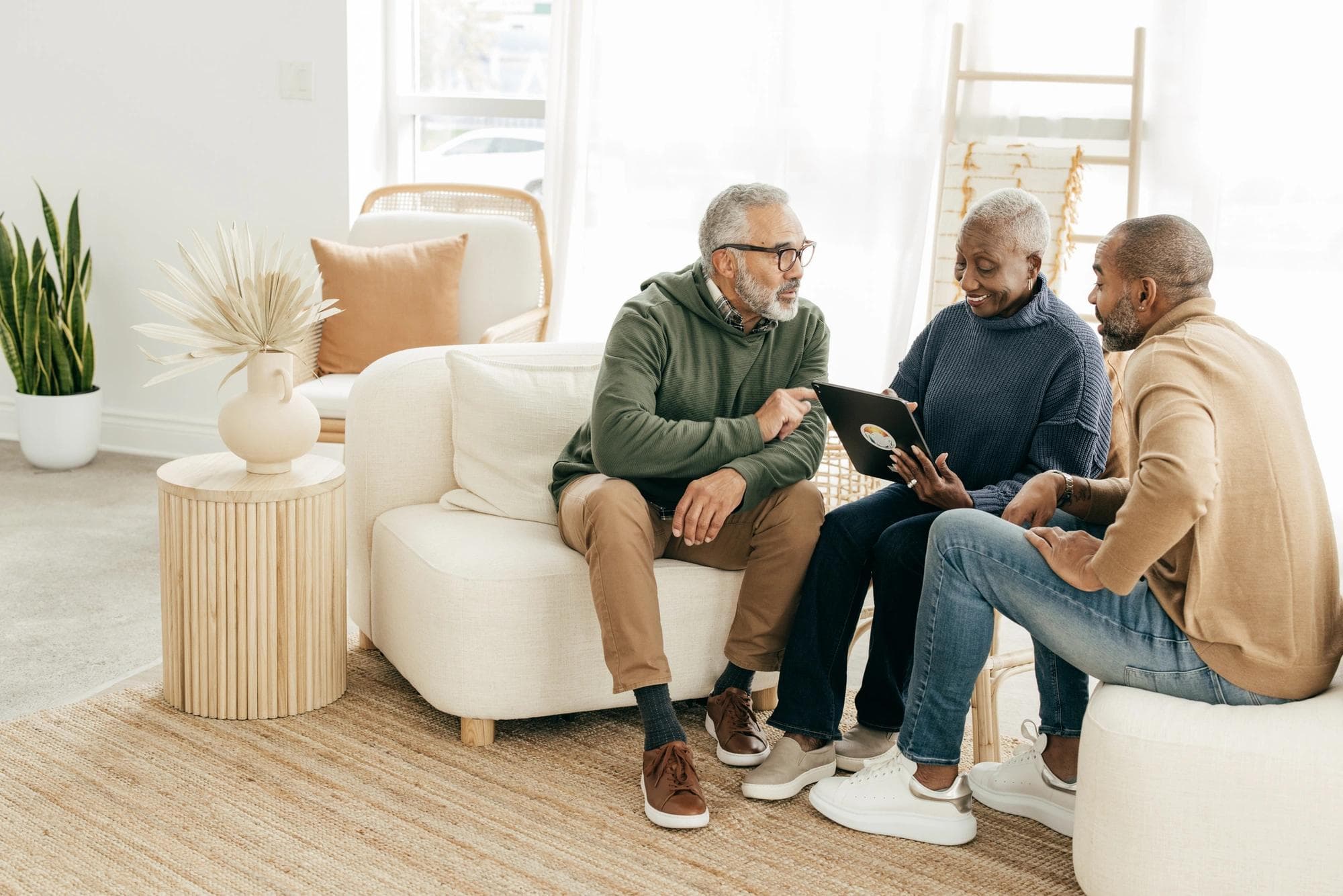 couple speaking to person with ipad