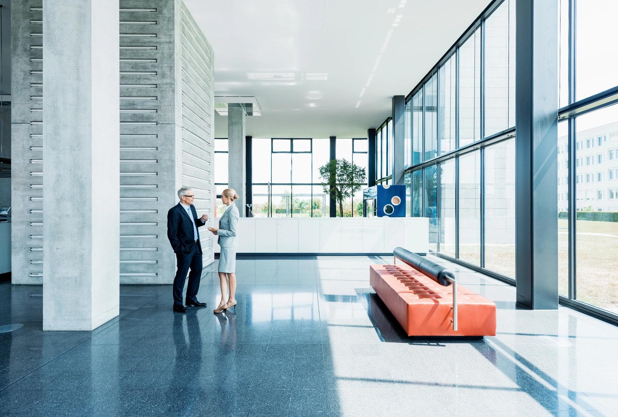 people having a conversation in office lobby