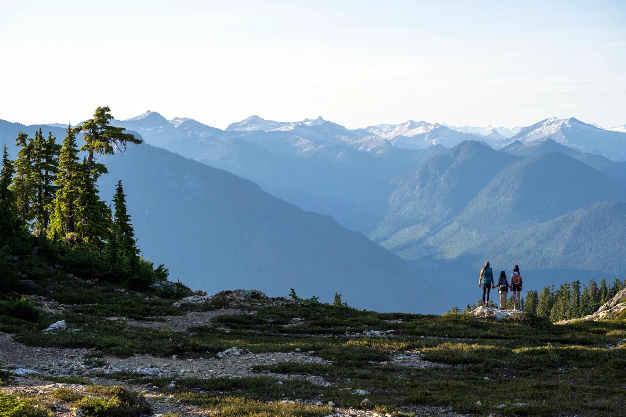 Mother and daughters hiking in the mountains. Nature and active lifestyle themes. Tetrahedron area of the Sunshine Coast.