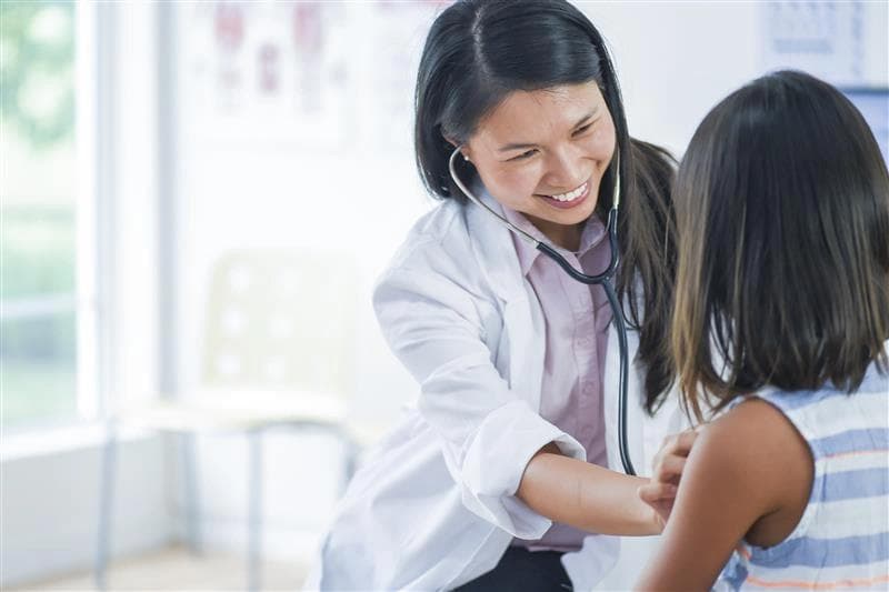 doctor examining child with stethoscope