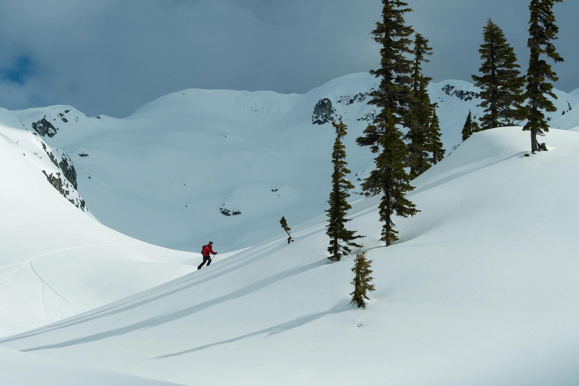 person climbing up snow covered hill