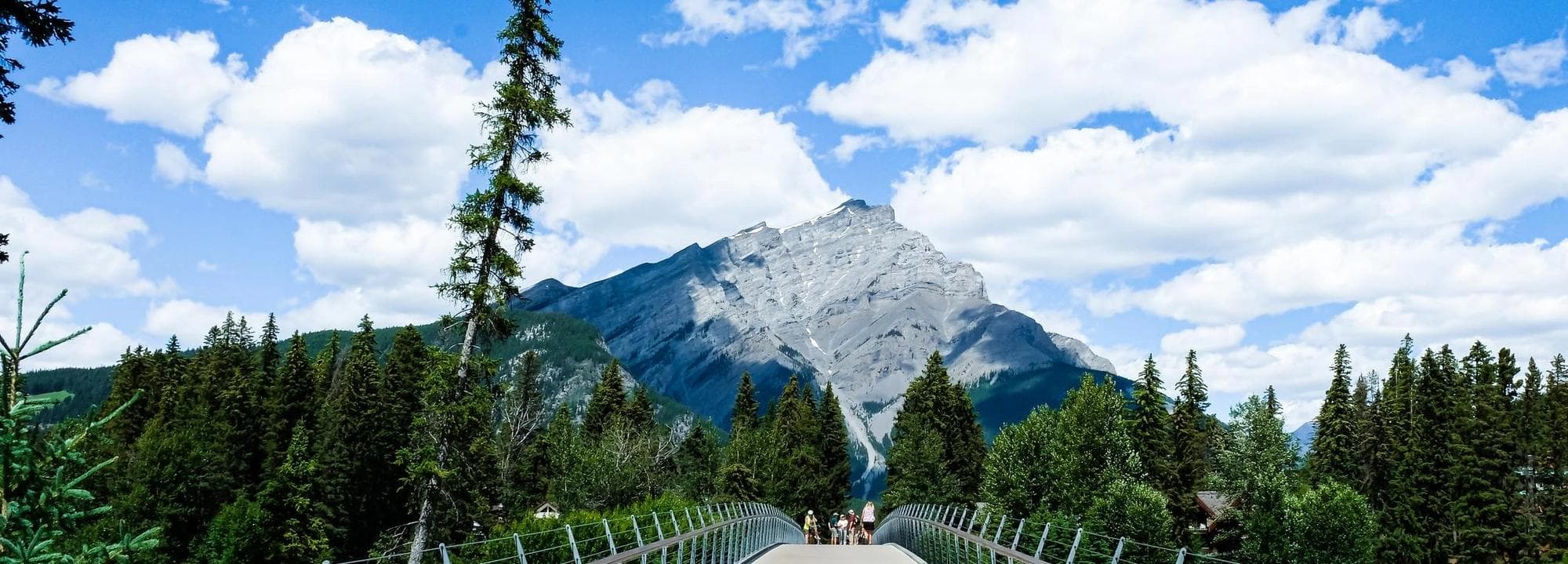 Bridge over river with mountains in the distance