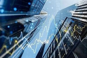 office buildings with stock ticker line graph superimposed