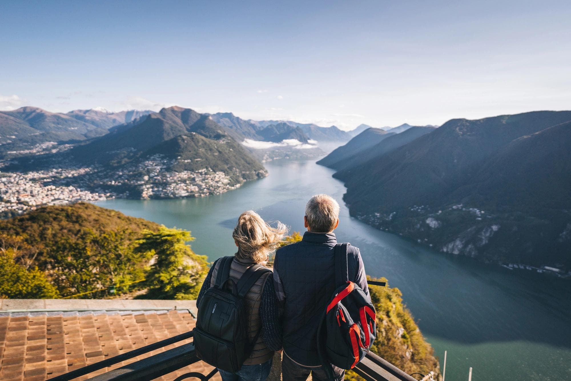 couple hiking looking at river vista